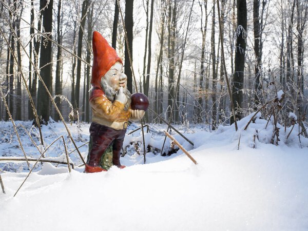 Garden gnome decoration in snowcapped woods