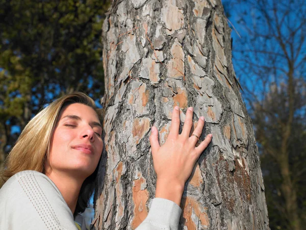 Woman hugging a tree