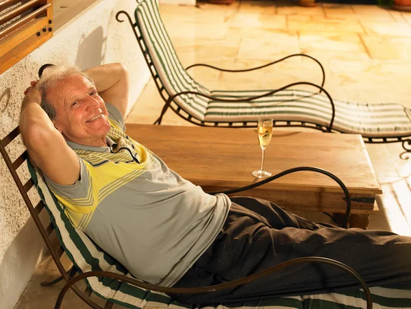 Senior Adult man lying on sun lounger