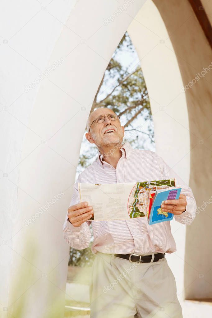 Older man with guidebooks