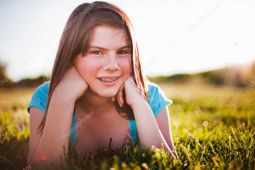 Young girl in grass smiling