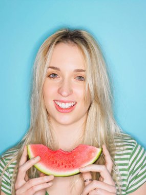 Young woman eating watermelon clipart