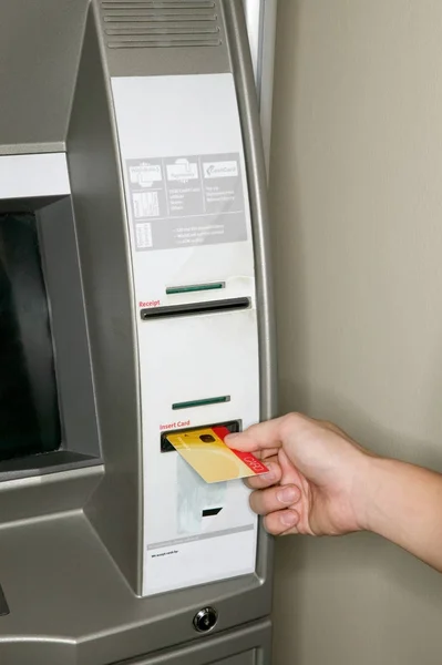 cropped shot of man using cash machine