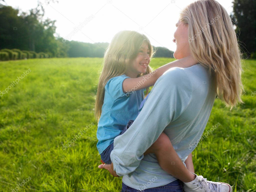 Mother and daughter playing in a field