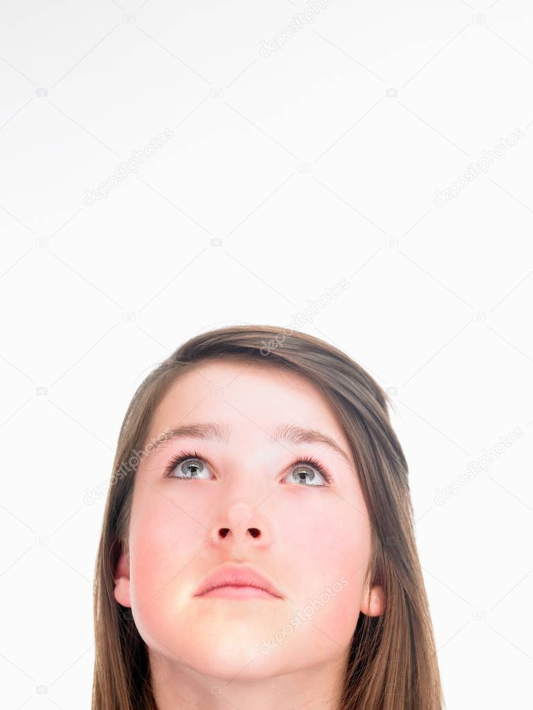 Girl looking up isolated on white background 