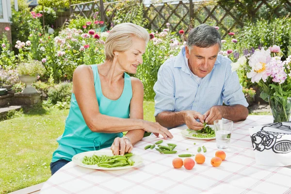 mature woman teaches partner to peel pod