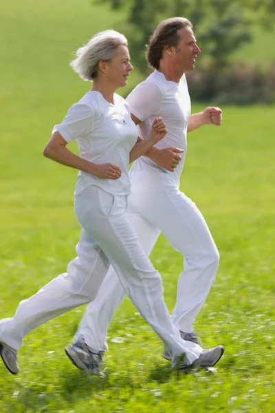 Mature couple running — Stock Photo, Image