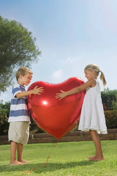 Niños Pequeños Abrazando Globo Rojo Del Corazón — Foto de Stock