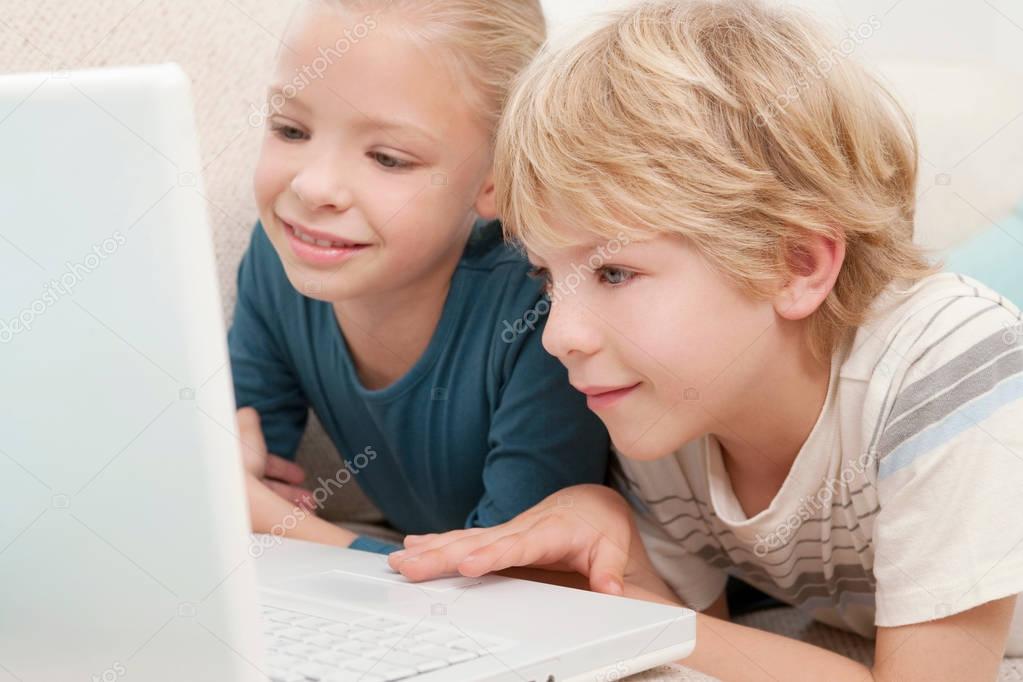 boy and girl using laptop