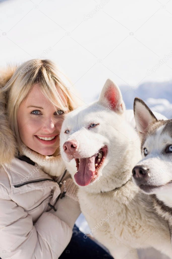 woman with two siberian huskies