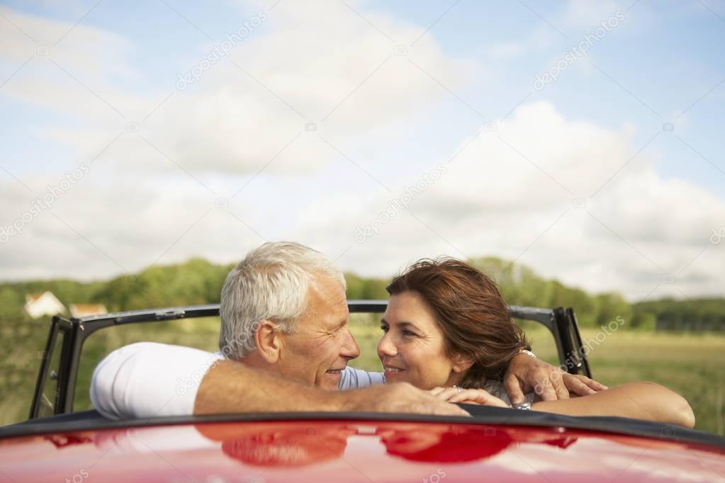 Couple hugging each other in car