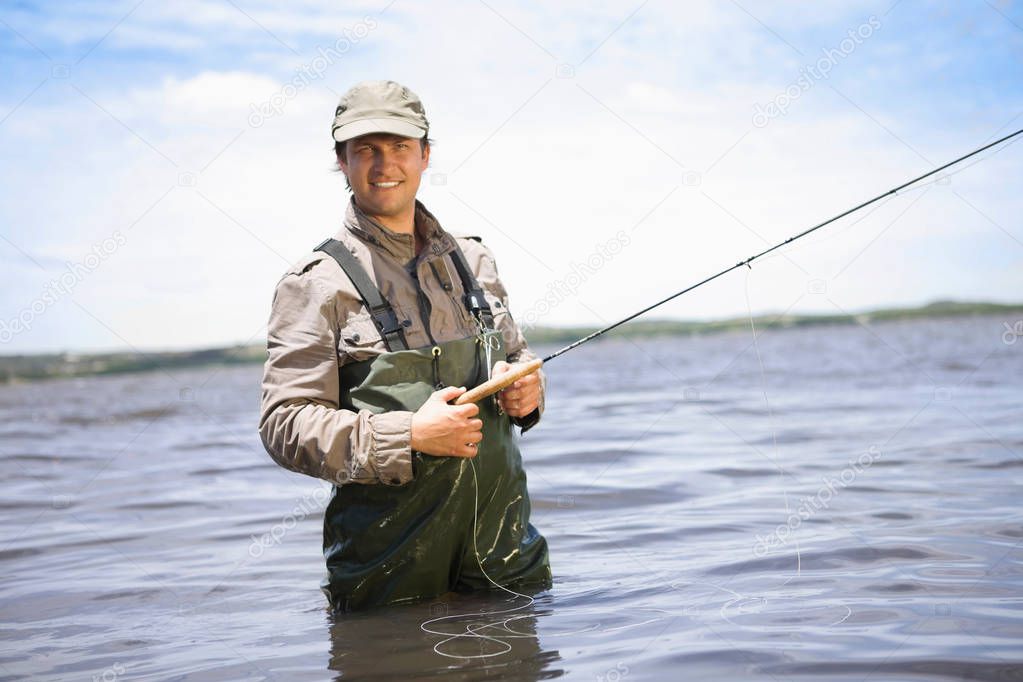 Portrait of a fisherman fishing in lake