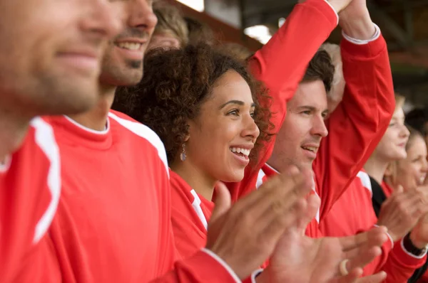 Fans clapping at football match