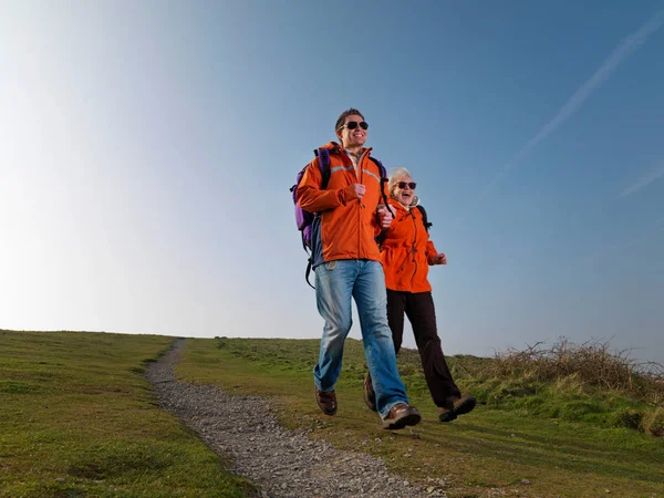 man & woman hiking and smiling