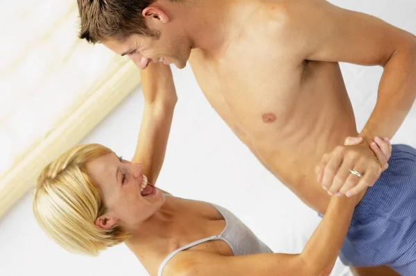 Heterosexual couple playing in underwear — Stock Photo, Image