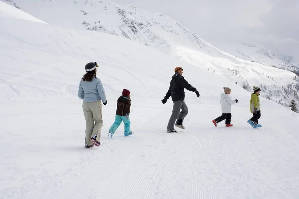 雪の中を歩く家族 — ストック写真