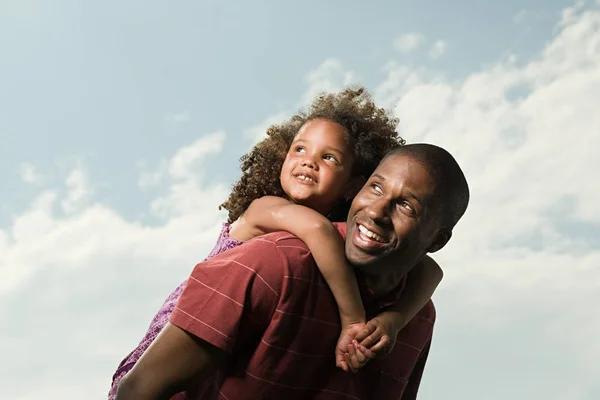 african american ethnicity father carrying daughter
