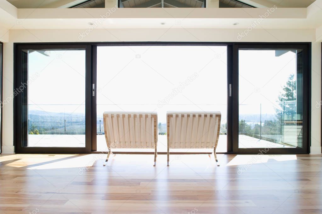 Inside view of Chairs by patio doors