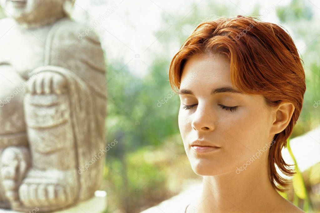 red hair woman practicing meditation  