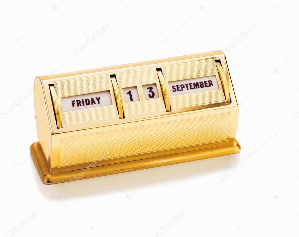 Golden table calendar with dates on white background