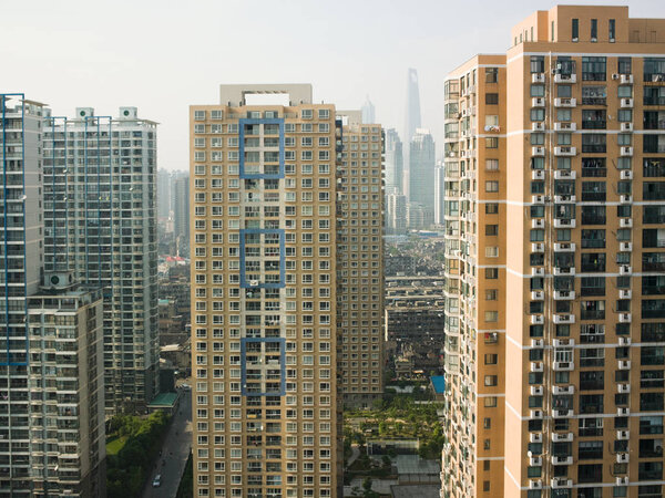 Shanghai apartment buildings with skyscrapers on background, China