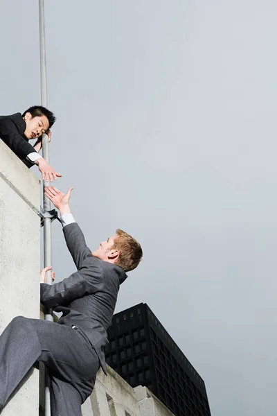 Businessman Reaching Colleague Wall — Stock Photo, Image