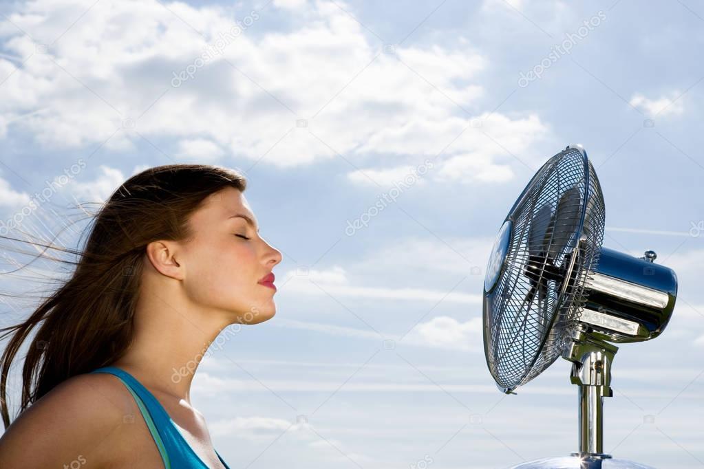 woman standing in front of fan