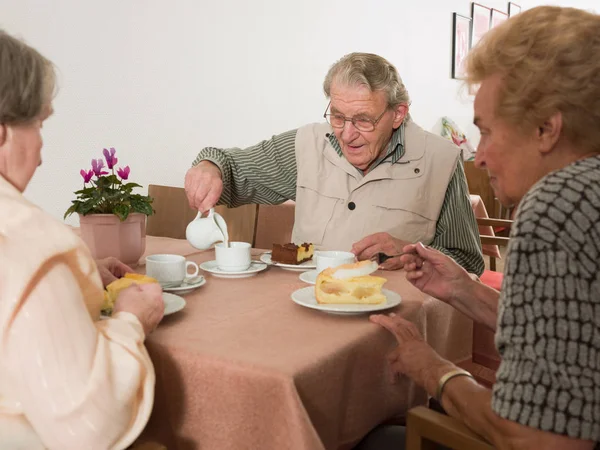 Seniors eating cake at home