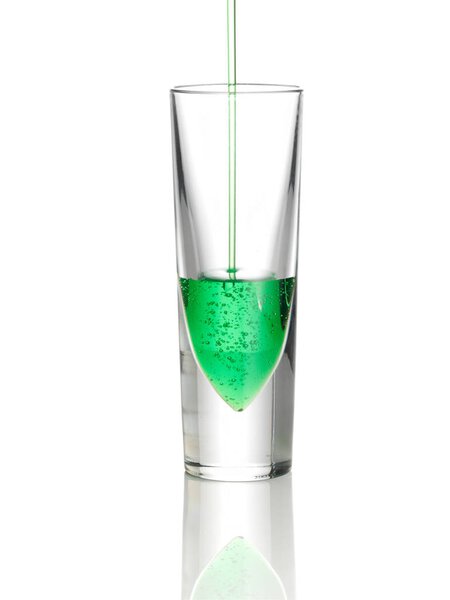 Green drink pouring into glass