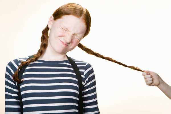 Girl Having Her Pigtail Pulled Royalty Free Stock Photos