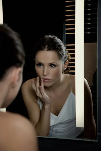 Woman in front of mirror close up