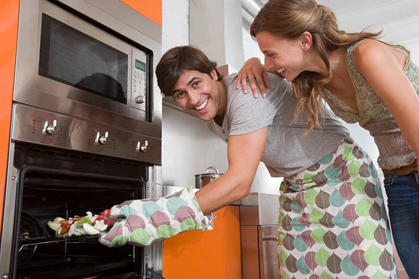 Couple Kitchen Man Putting Food Baking Oven — Stock Photo, Image