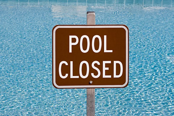 Pool closed sign near swimming pool