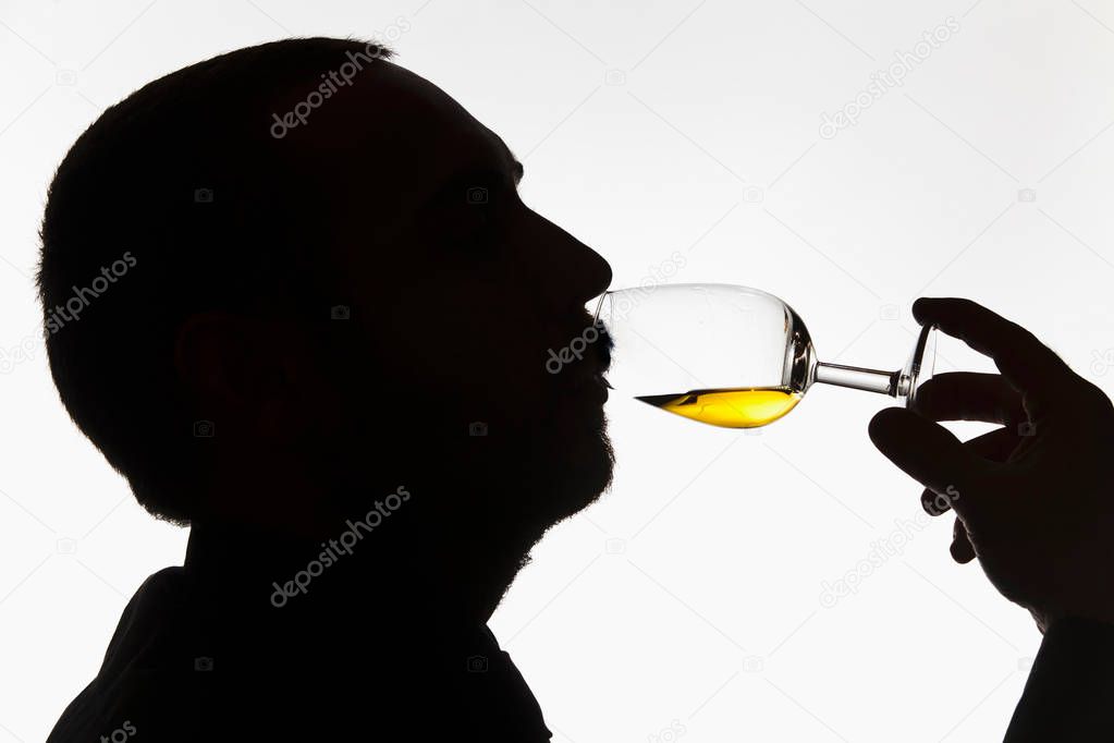 Worker tasting whisky in distillery