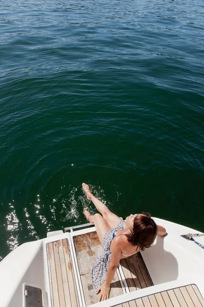 Senior Woman Dangling Feet Sailboat — Stock Photo, Image