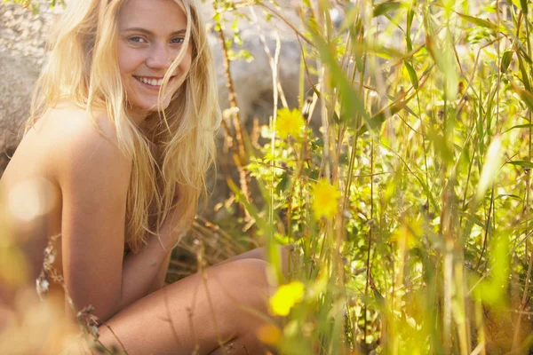 Young woman nude in long grass