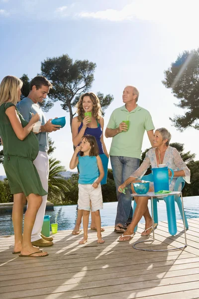 group portrait of happy Family on a wooden terrace by a pool