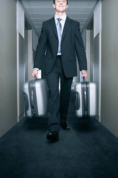 Man Carrying Suitcases Hallway Stock Photo