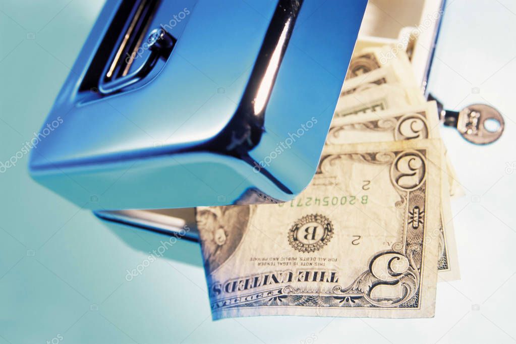Close up view of open cash box with american dollar banknotes 