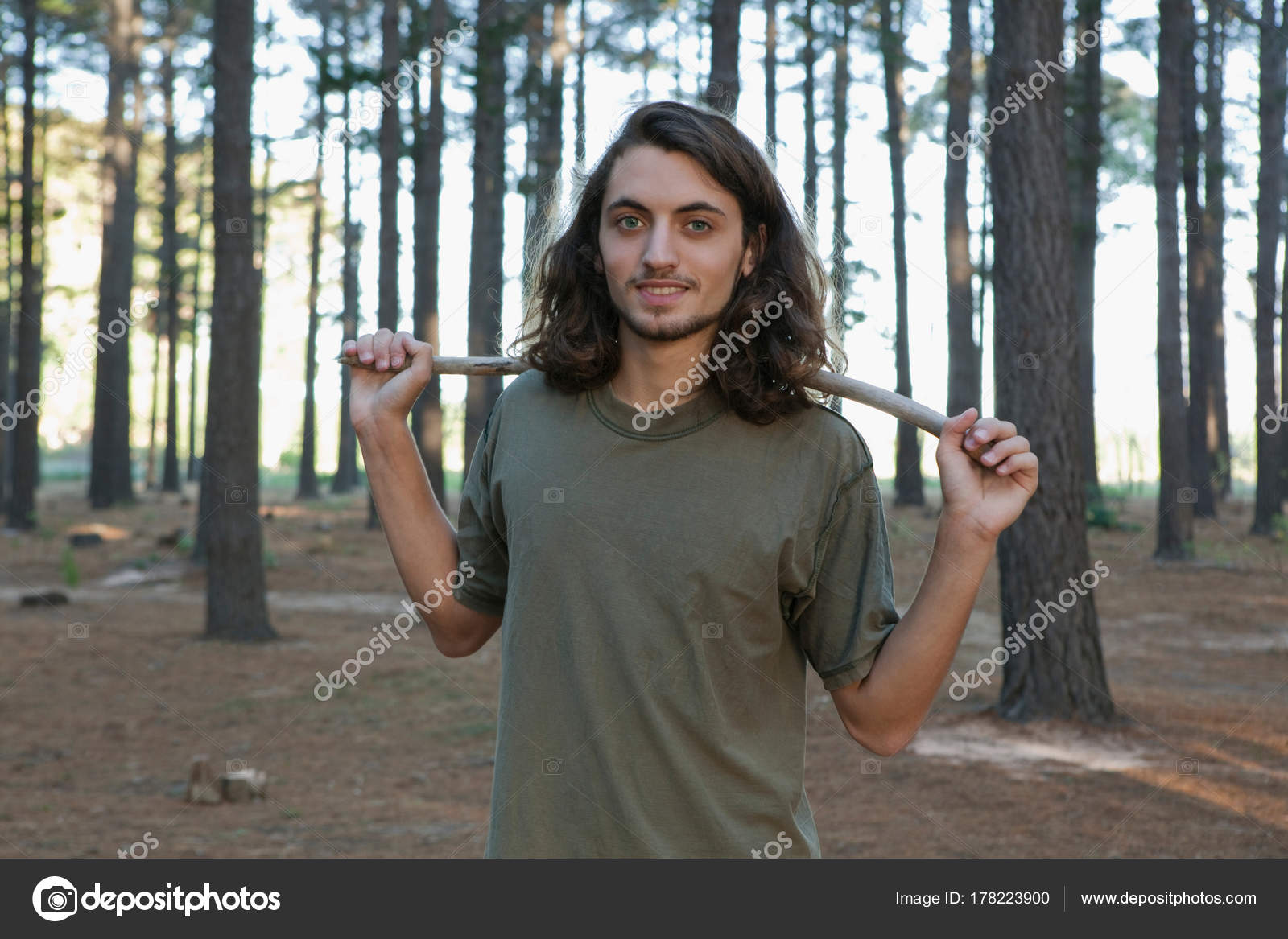 Man Holding Stick Forest — Stock Photo © ImageSource 178223900