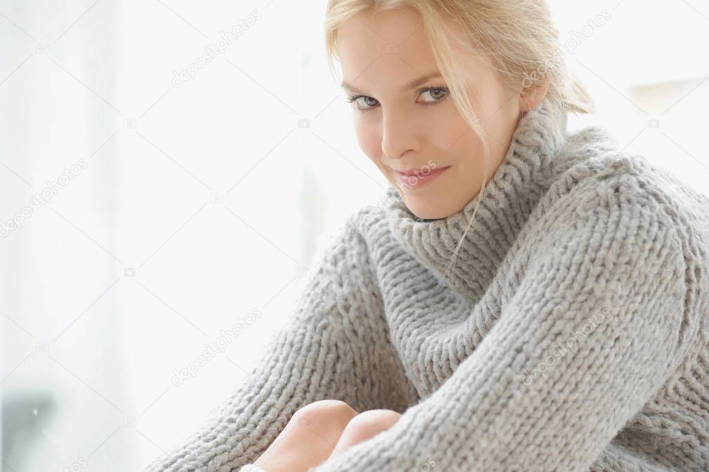 young attractive caucasian woman wearing thick sweater