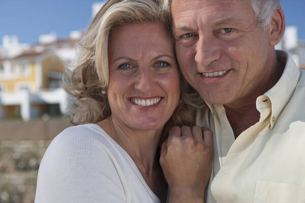 portrait of caucasian mature adult couple by property development