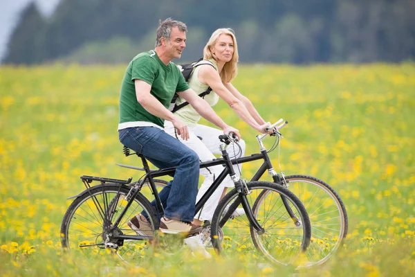 Happy Couple Riding Bikes Stock Photo