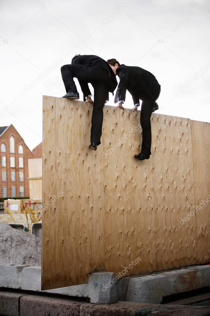 To men climbing wall