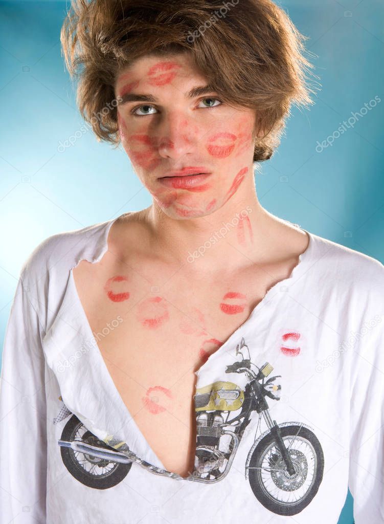 Young cute man covered in many kisses