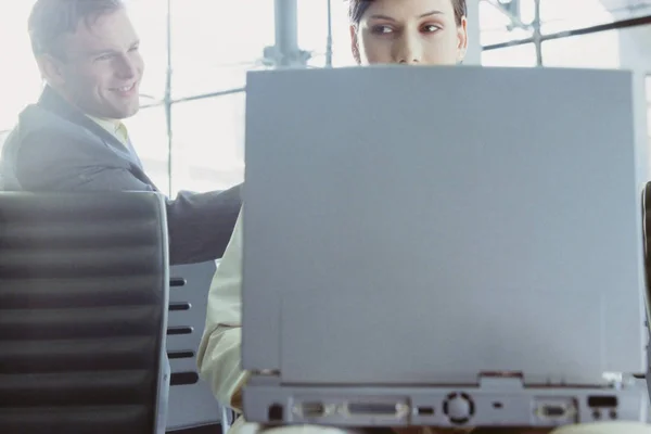 Businessman and businesswoman meeting in airport lounge