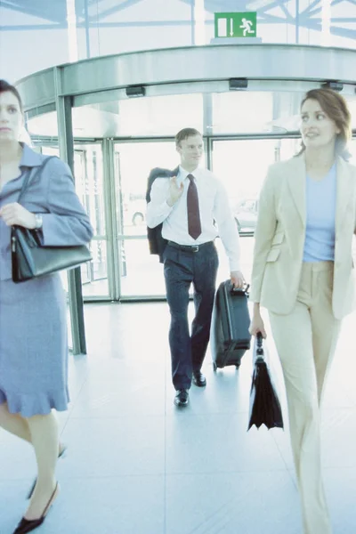 Businesspeople in airport terminal, business concept background