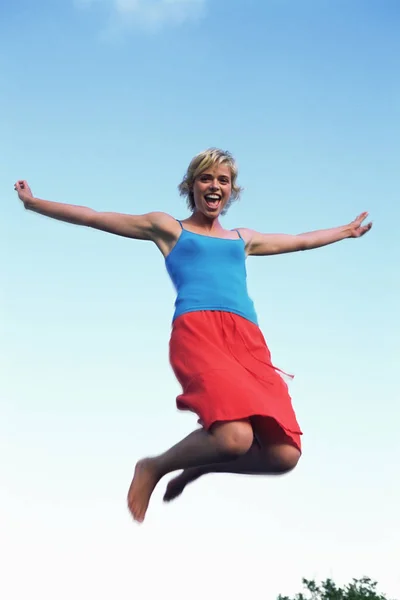 Young Woman Jumping Blue Sky Royalty Free Stock Images