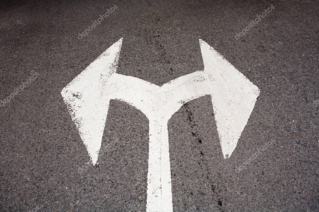Arrow signs on asphalt 