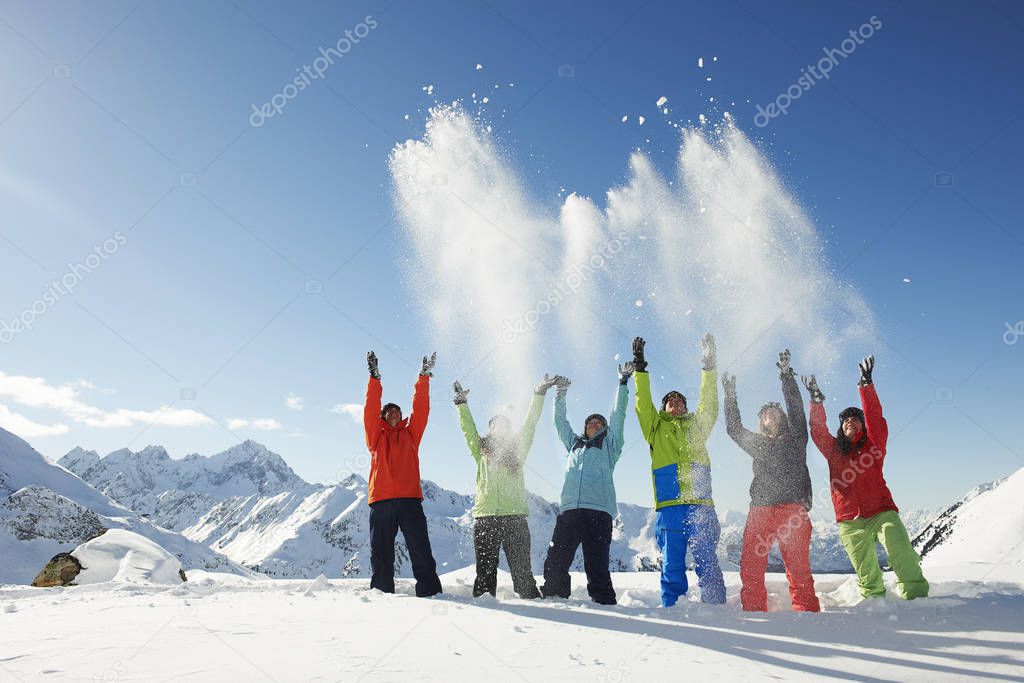 Friends throwing snow mid-air, Kuhtai, Austria